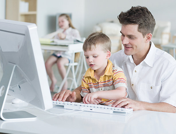 Man and boy with computer