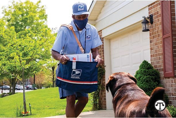 Annapolis, MD letter carrier Thomas Tyler takes a protective stance against an approaching dog.