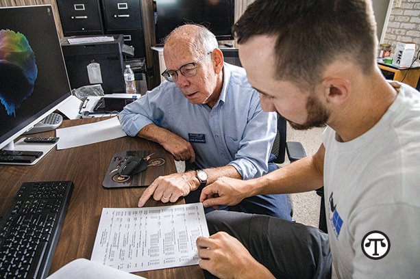 There are many options for financing a business and a mentor can help guide you. Pictured: Aaron Mulherin, owner of AM Glass and his SCORE mentor, John Brockhardt.